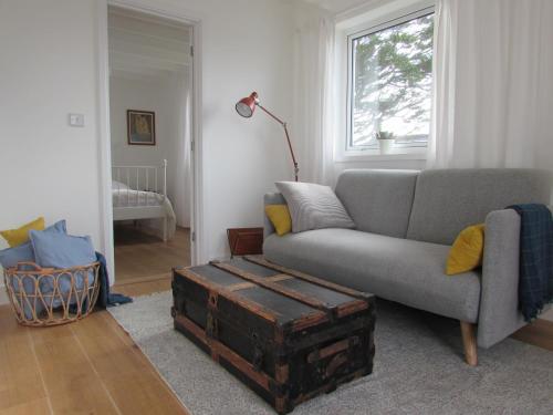 a living room with a couch and an old trunk at White Willows in Praa Sands