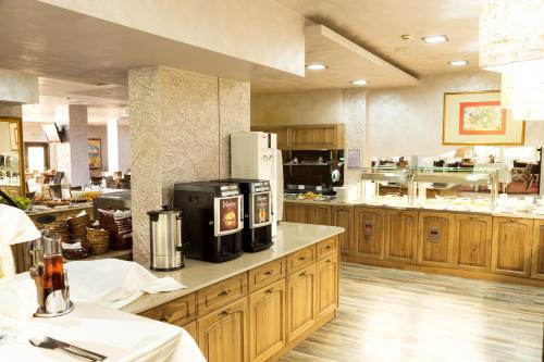 a large kitchen with wooden cabinets and a counter top at Balneo Complex & Spa Aquatonik in Velingrad