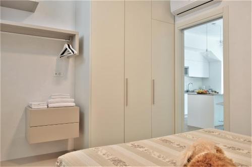 a bedroom with a bed and a door to a kitchen at Casa Mamma Pina in Arco