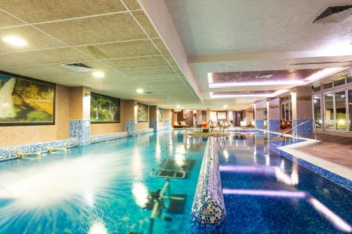 a large swimming pool in a hotel room at Balneo Complex & Spa Aquatonik in Velingrad