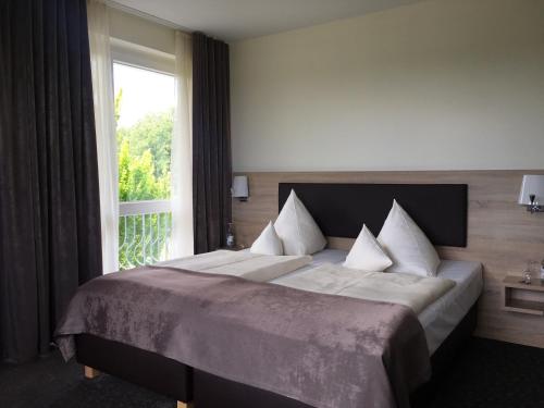 Un pat sau paturi într-o cameră la Restaurant und Hotel Knostmann