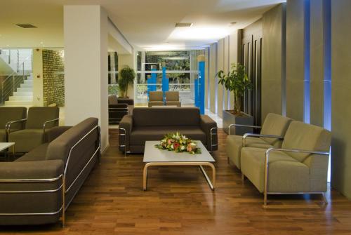 a living room filled with furniture and a couch at Kos Aktis Art Hotel in Kos