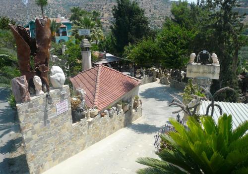 a stone wall with a building with a house at Greenfields Country Club in Limassol