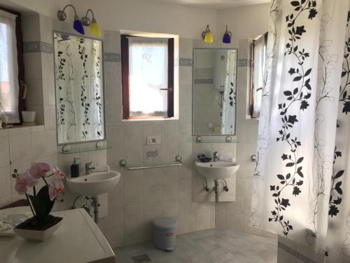 a bathroom with two sinks and a mirror at Apartments Villa Laura in Pula