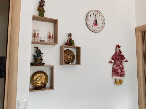 a wall with shelves and a clock on it at La Santera in Marina di Davoli