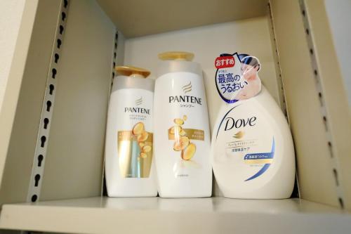 three bottles of cleaning products sitting on a shelf at Near Nakajima park Close to Susukino Anbiennte 101 in Sapporo