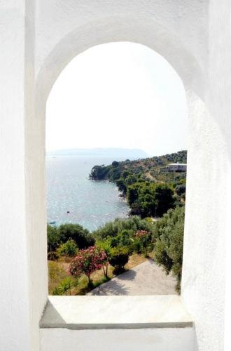 a view of the ocean through an arch window at Nemesis in Neo Klima