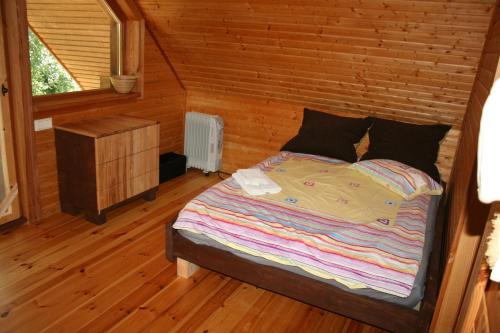 een slaapkamer met een bed met een bakstenen muur bij Jaunzemji in Dzeņi