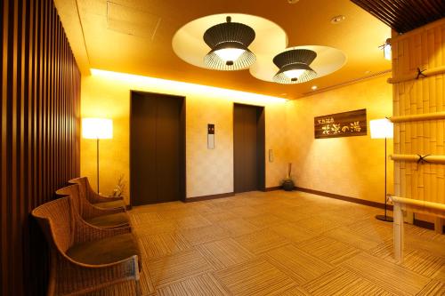 a large room with chairs and lights on the ceiling at Dormy Inn Premium Kyoto Ekimae Natural Hot Spring in Kyoto