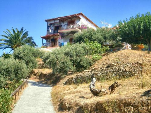 a house on top of a hill with a dirt road at Nemesis in Neo Klima