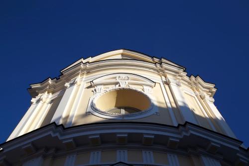 a white tower with a clock on top of it at Maison Gioffredi in Ischia