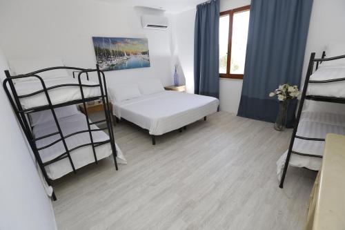 a room with a bed and two bunk beds at Appartamenti Feel Good in Rimini