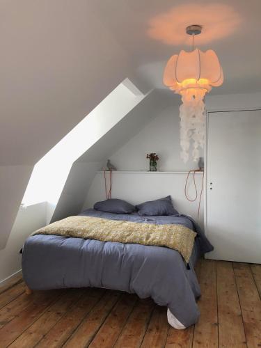 une chambre avec un lit dans un grenier dans l'établissement hotel de Croix, à Morlaix