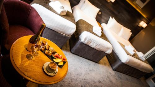 a table with a bottle of champagne and a plate of food at Heywood Spa Hotel in Tenby