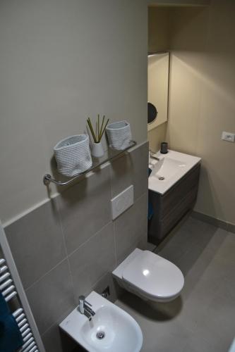 a bathroom with a toilet and a sink at DOMUS LINGOTTO in Turin