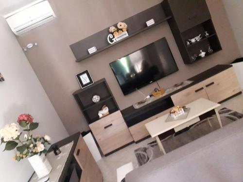 a living room with a flat screen tv on the wall at Gio's house in Collemeto