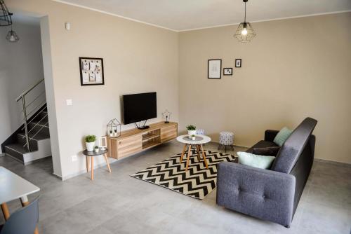 a living room with a couch and a tv at Penzión Fonte in Radava
