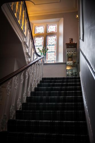 a staircase in a house with a stair case at Heywood Spa Hotel in Tenby
