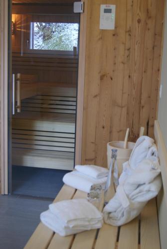 a sauna with towels sitting on a wooden floor at Hotel Ucliva in Waltensburg