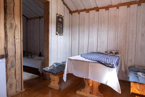 a room with a table in a wooden cabin at Ungru Holiday Houses in Suuresadama