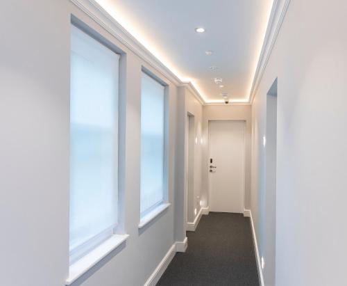 a hallway with large windows in a building at NOX West Hampstead in London