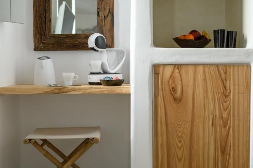a kitchen with a mirror and a wooden cabinet at The Summit of Mykonos in Kalo Livadi