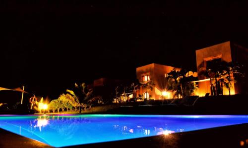 a night view of a swimming pool with blue lights at Vipingo Ridge-Swahili Villa in Mombasa