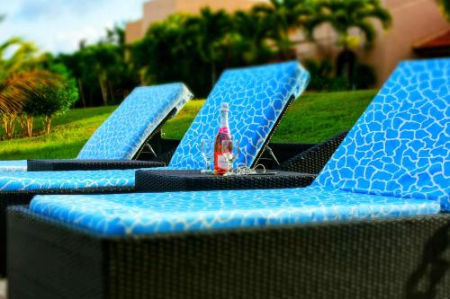 a group of blue chairs with a bottle on them at Vipingo Ridge-Swahili Villa in Mombasa