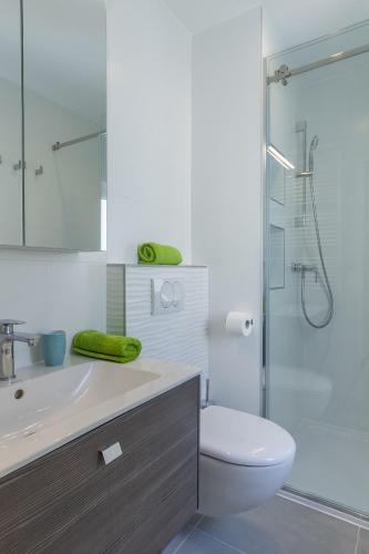 a bathroom with a sink and a toilet and a shower at Villas Katja & Hana by Pag tours in Kolan