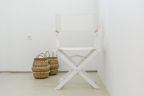 a white table with baskets on it in a room at The Summit of Mykonos in Kalo Livadi