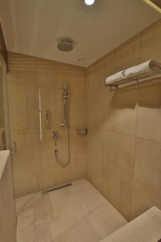 a bathroom with a shower and a walk in shower at Sayaji Rajkot in Rajkot