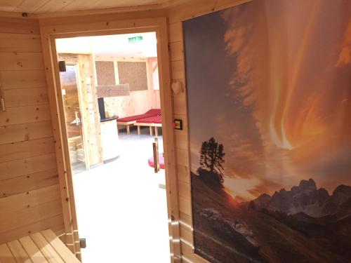a room with a large painting on the wall at Berghotel Alpenklang in Grossarl