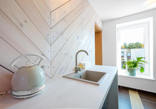 a kitchen with a mixer on a counter next to a sink at Ośrodek wypoczynkowy Balt-Tur Feel Well Resort in Jastrzębia Góra