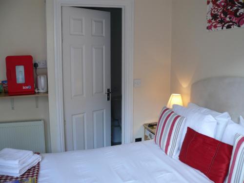 a white bed sitting in a bedroom next to a door at Bow Street Runner in Brighton & Hove