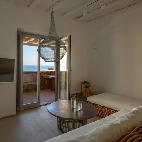 a living room with a couch and a table at The Summit of Mykonos in Kalo Livadi