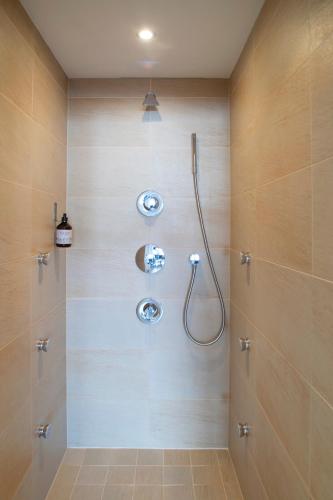 a bathroom with a shower with a glass door at Pension Alpenfluh in Lech am Arlberg