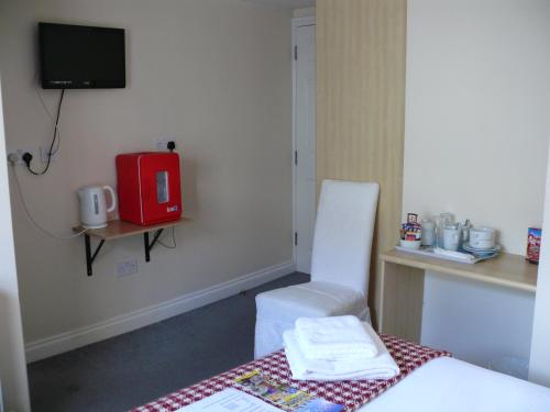 a hotel room with a bed and a phone at Bow Street Runner in Brighton & Hove