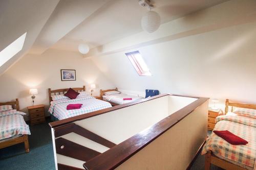 a attic bedroom with two beds in a room at Lower Micklin Farm in Alton