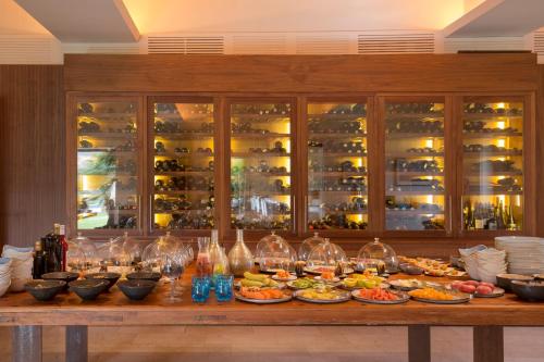 a table with plates of food and wine glasses at Can Simoneta - Adults Only in Canyamel