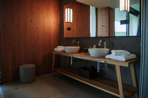 a bathroom with two sinks and a mirror at Lajvér Borbirtok in Szálka