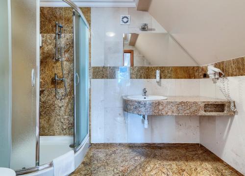 a bathroom with a sink and a shower at Villa Palladium in Gdańsk