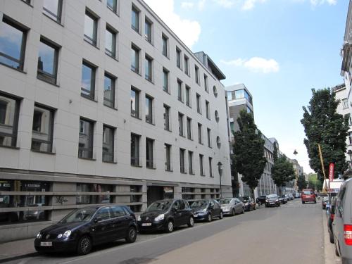 a row of cars parked in front of a building at Modern Apartment Second Floor in Brussels