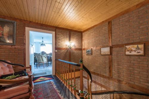a staircase in a room with a brick wall at Deichschatz in Mittelnkirchen