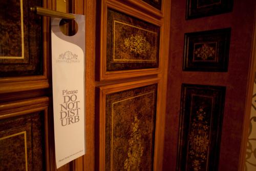 a door with a sign that says do not disturb at Deminka Palace in Prague