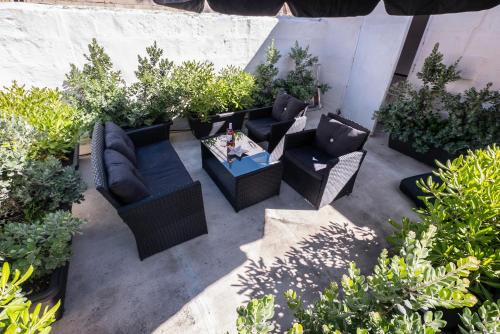 an overhead view of a patio with furniture and plants at Valletta Kampnar City Living in Valletta