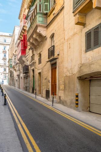 an empty street in a city with buildings at Valletta Kampnar City Living in Valletta