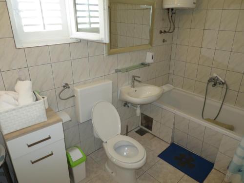 a small bathroom with a toilet and a sink at Apartments Milica in Rogoznica