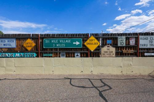 a fence with signs on the side of a road at Red Rock Motel and Dam Motel in Page