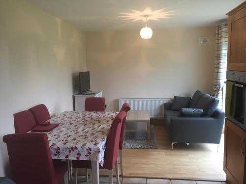 a kitchen and living room with a table and a couch at 39 woodview in Listowel