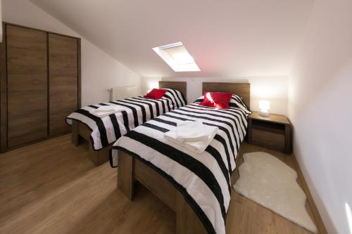 a room with three beds in a room at House Smolčić in Otočac